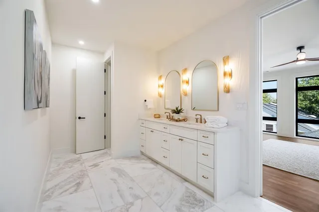 a spacious bathroom with a double vanity sink and a mirror