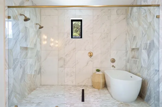 a bathroom with a bathtub and shower