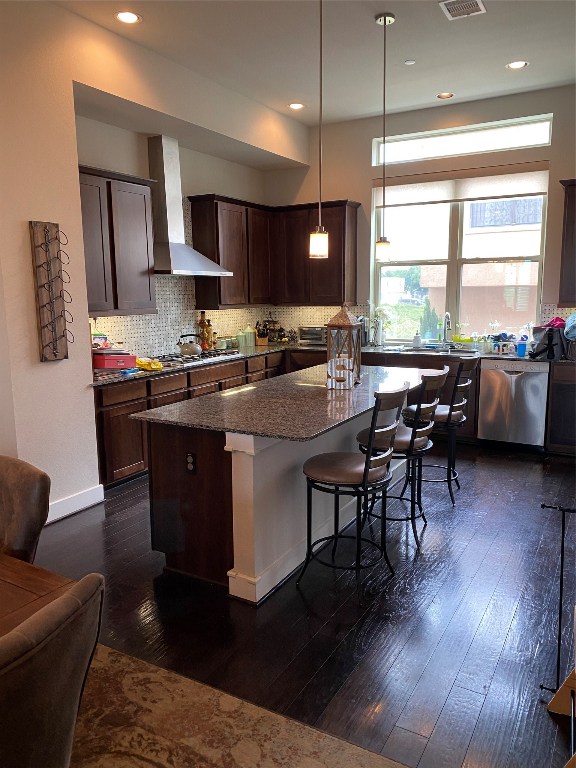 115 East 2nd Street Houston, TX 77007 - Photo 19 of 37 a kitchen with stainless steel appliances granite countertop a stove a sink dishwasher a dining table and chairs with wooden floor