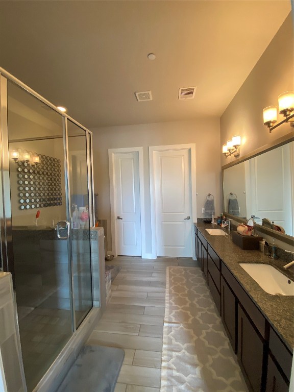 115 East 2nd Street Houston, TX 77007 - Photo 24 of 37 a bathroom with a granite countertop sink a large mirror and a shower