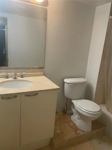 a bathroom with a sink toilet and vanity