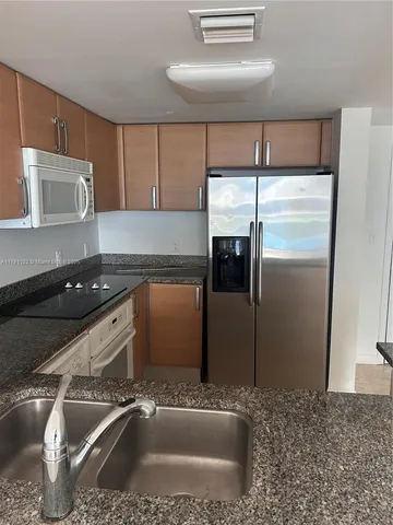 a kitchen with a refrigerator and a sink