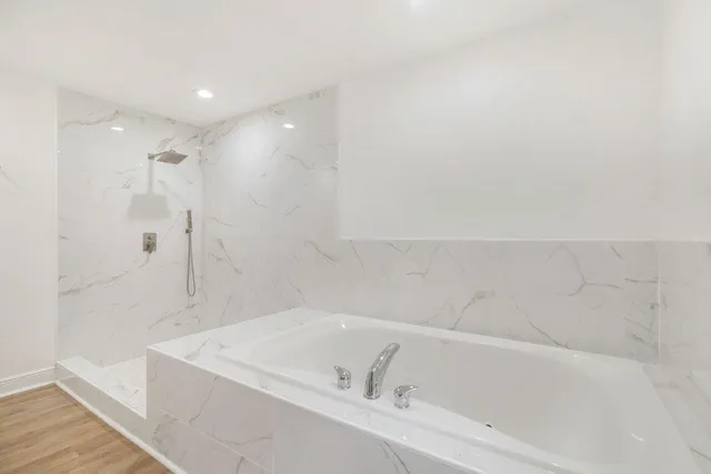 a white bath tub sitting in a bathroom