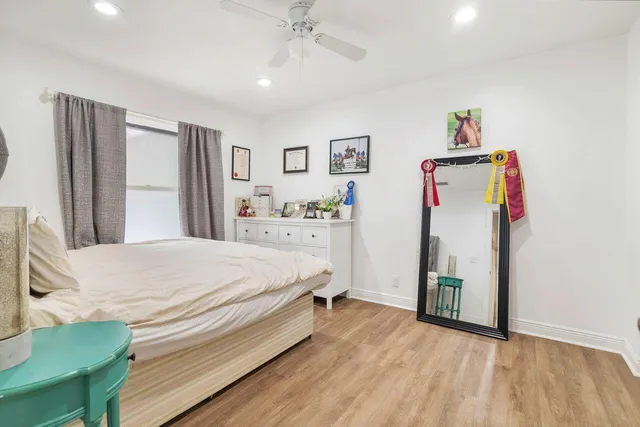 a bed room with a bed mirror and a window