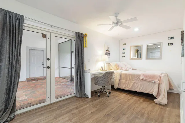a spacious bedroom with a bed and a chandelier