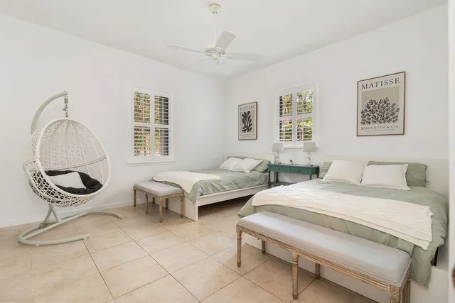 a spacious bedroom with two beds and a window