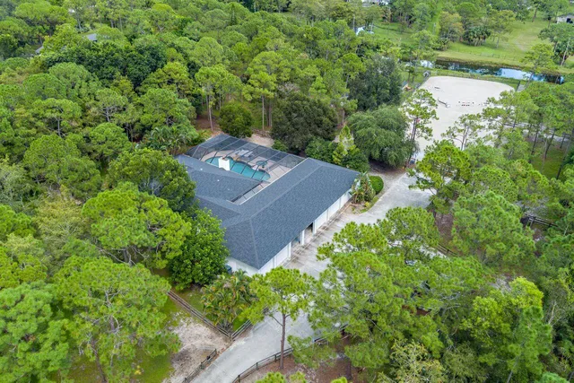 an aerial view of a house with a yard and outdoor seating