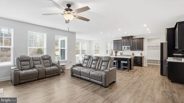 a living room with furniture and kitchen view