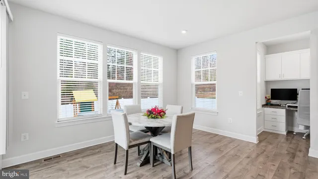 a dining room with furniture and wooden floor