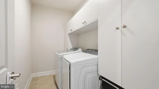 a bedroom with a bed a flat screen tv and a couch