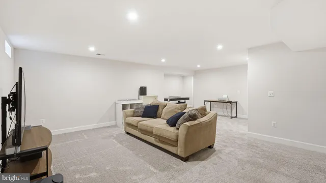 a view of a workspace with furniture and a bookshelf