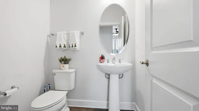 a bathroom with a sink toilet and a mirror