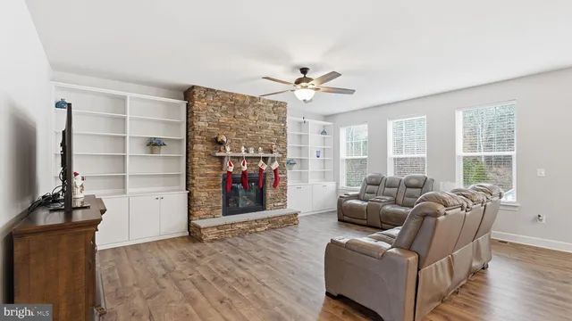 a living room with furniture a flat screen tv and a large window