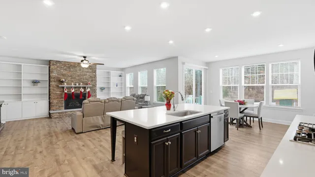 a large kitchen with kitchen island a sink table and chairs
