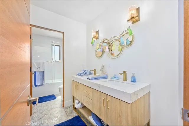 a bathroom with a sink mirror and vanity