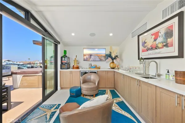 a kitchen with a sink cabinets and wooden floor