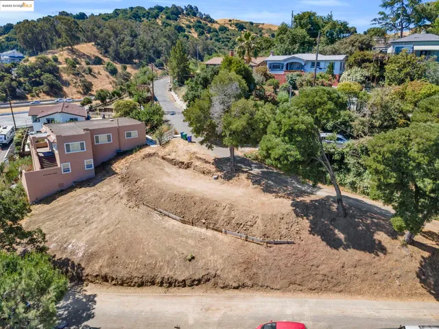 an aerial view of a house with a yard and parking space