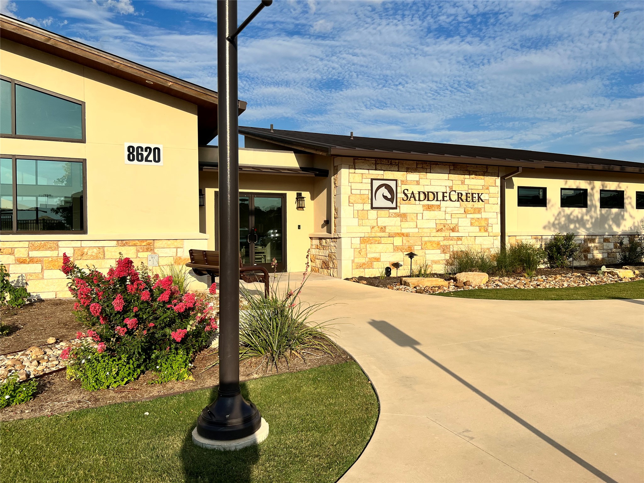 140 Pentro Path Georgetown, TX 78626 - Photo 22 of 37 A contemporary commercial building showcases a refined facade with stone accents and manicured landscaping.
