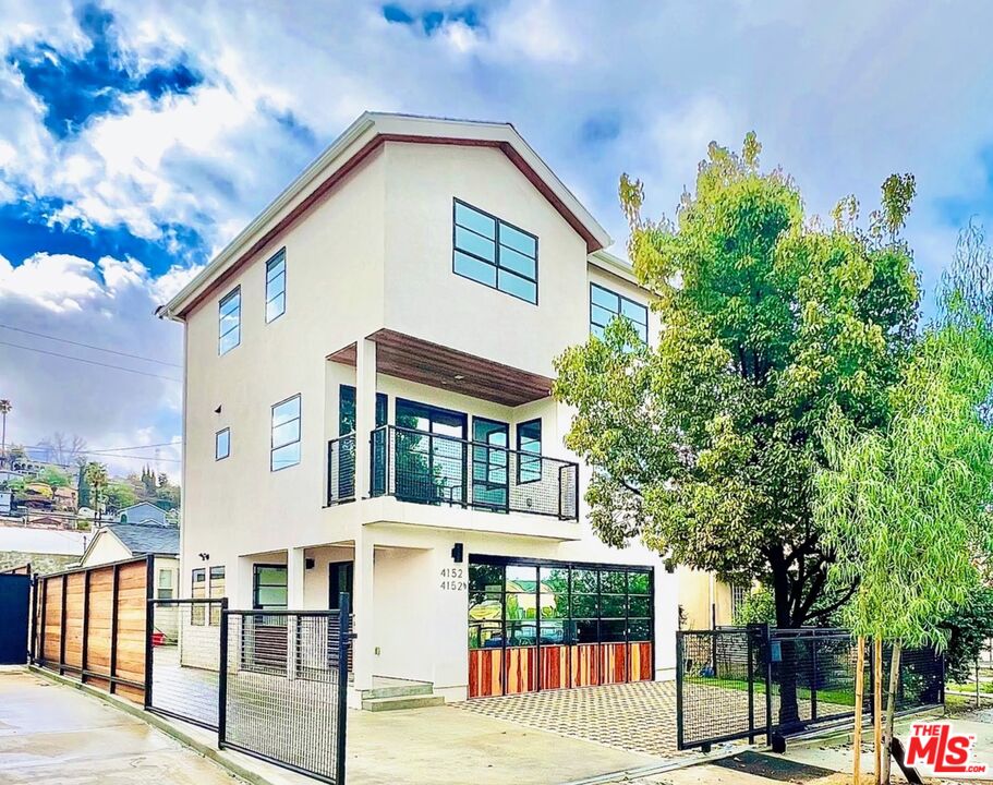 4152 1/2 Rogers Street, Unit 1/2 Los Angeles, CA 90063 - Photo 1 of 21 a front view of a house with a tree