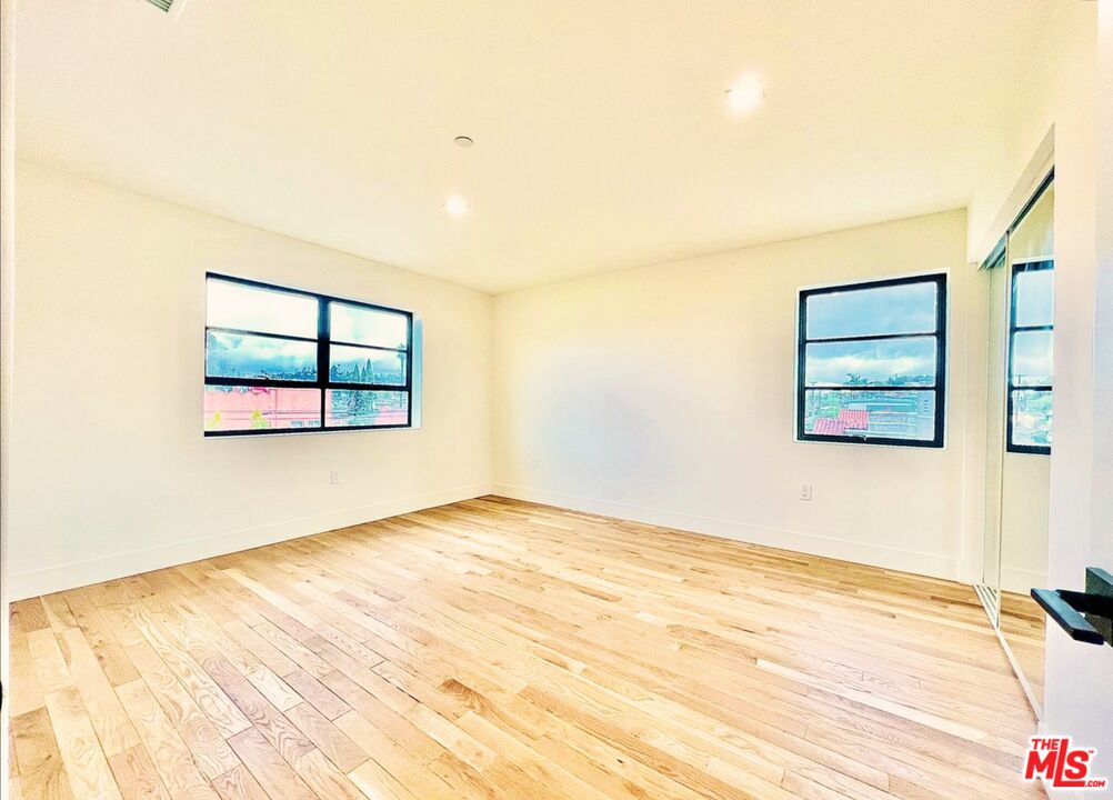 4152 1/2 Rogers Street, Unit 1/2 Los Angeles, CA 90063 - Photo 13 of 21 a view of a room with wooden floor and white walls