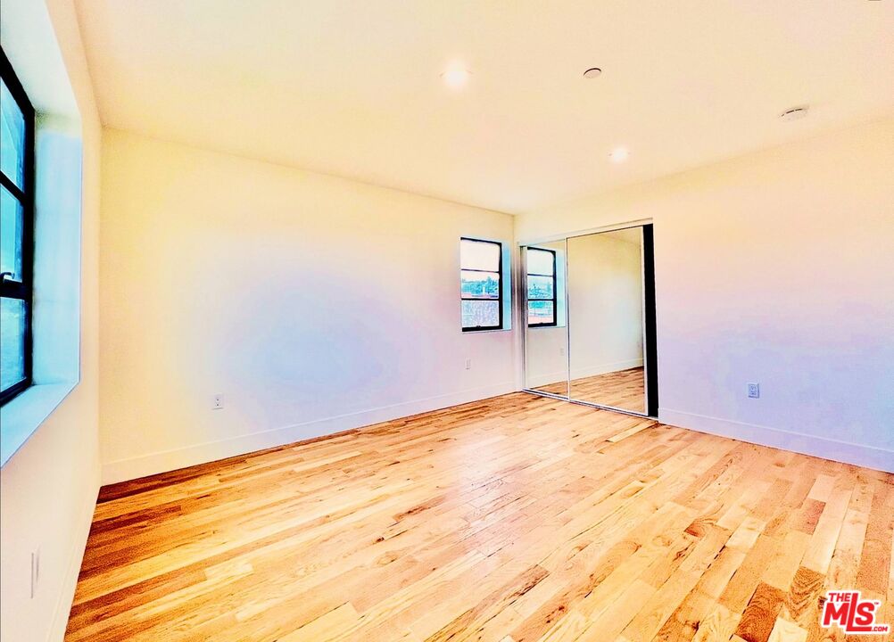 4152 1/2 Rogers Street, Unit 1/2 Los Angeles, CA 90063 - Photo 15 of 21 a view of empty room with wooden floor and fan