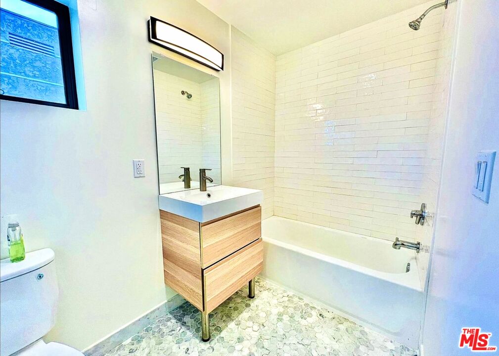 4152 1/2 Rogers Street, Unit 1/2 Los Angeles, CA 90063 - Photo 16 of 21 a bathroom with a tub sink and toilet