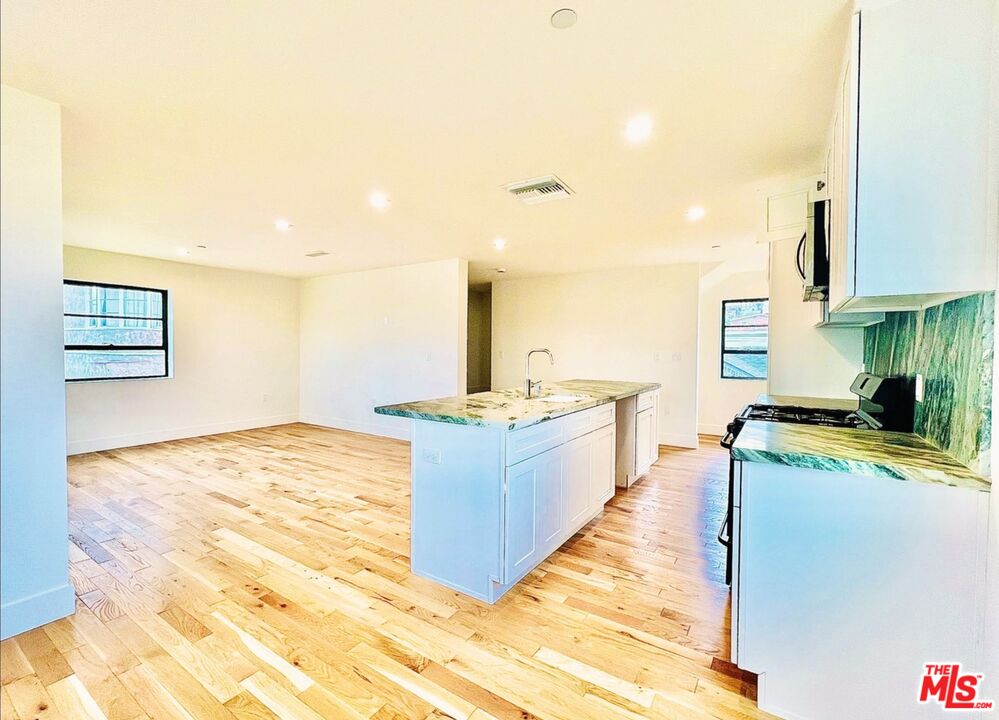 4152 1/2 Rogers Street, Unit 1/2 Los Angeles, CA 90063 - Photo 5 of 21 a large kitchen with kitchen island a sink stainless steel appliances and cabinets