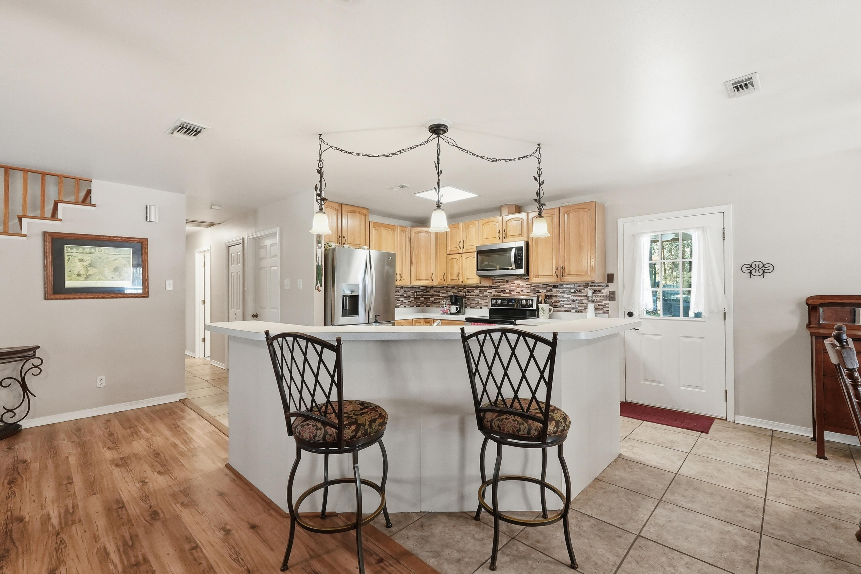 675 Spring Lake Road DeFuniak Springs, FL 32433 - Photo 16 of 91 a view of a dining room with furniture and a chandelier
