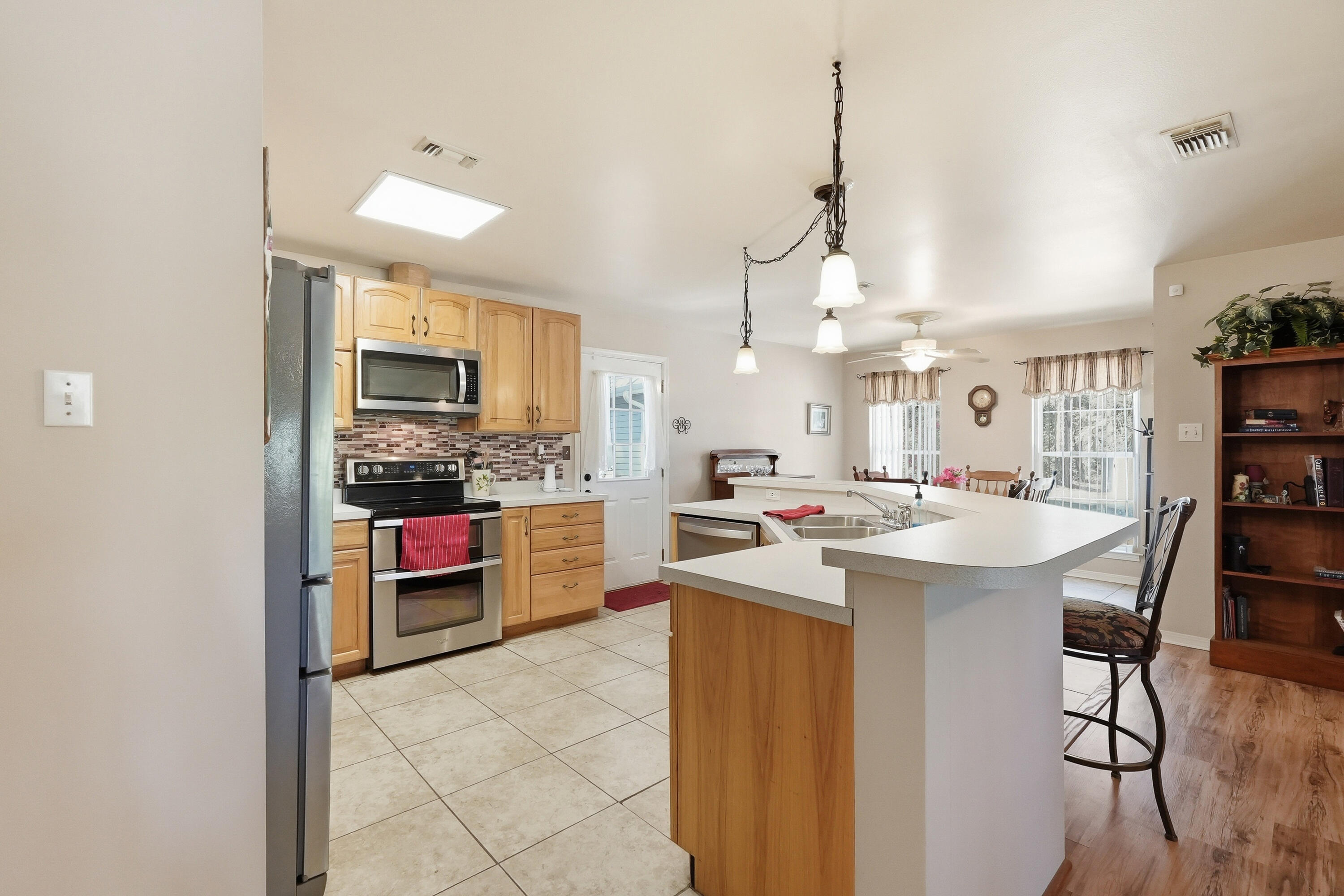 675 Spring Lake Road DeFuniak Springs, FL 32433 - Photo 17 of 91 a kitchen with kitchen island a sink stove and chairs
