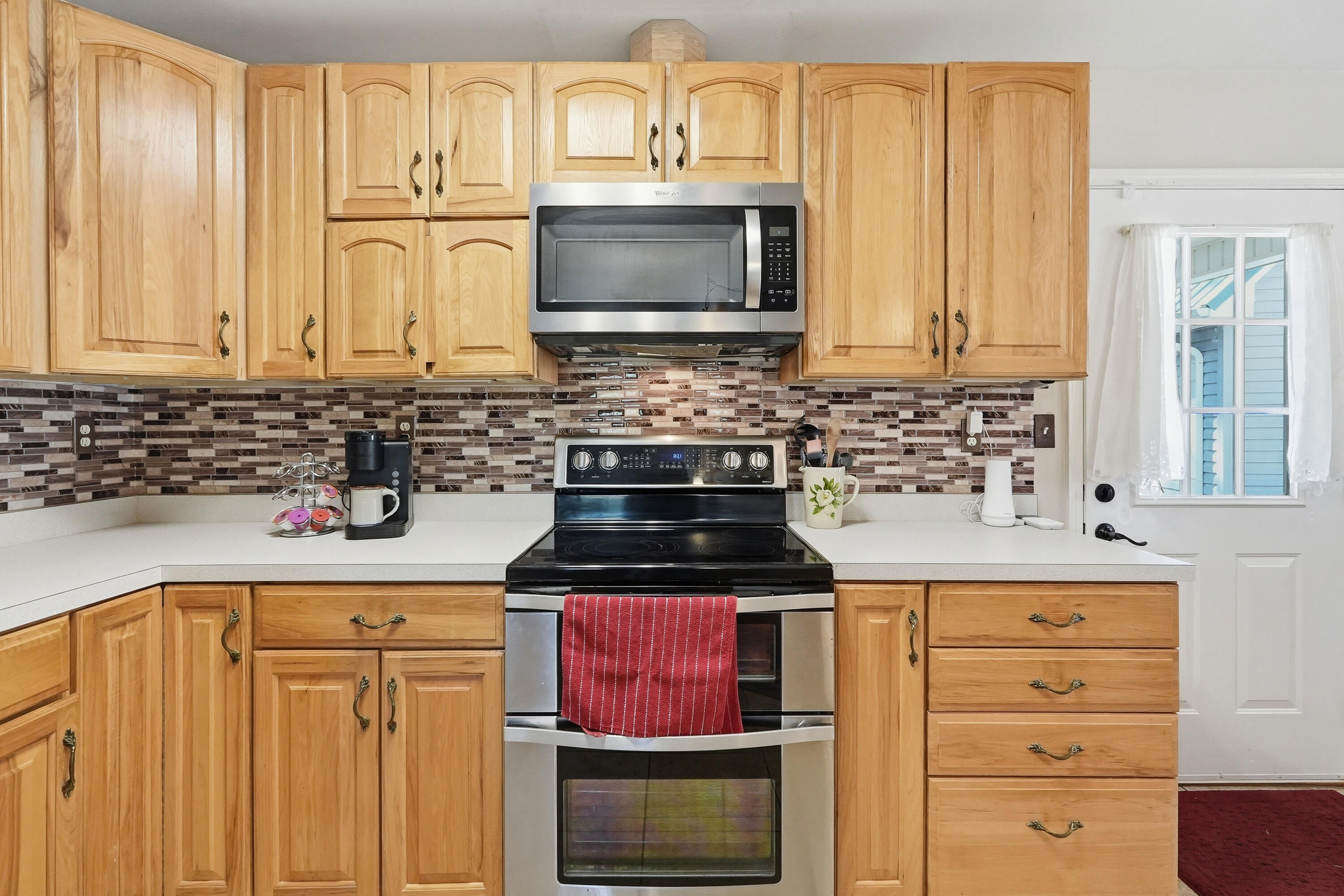 675 Spring Lake Road DeFuniak Springs, FL 32433 - Photo 22 of 91 a kitchen with stainless steel appliances a stove a sink and a microwave