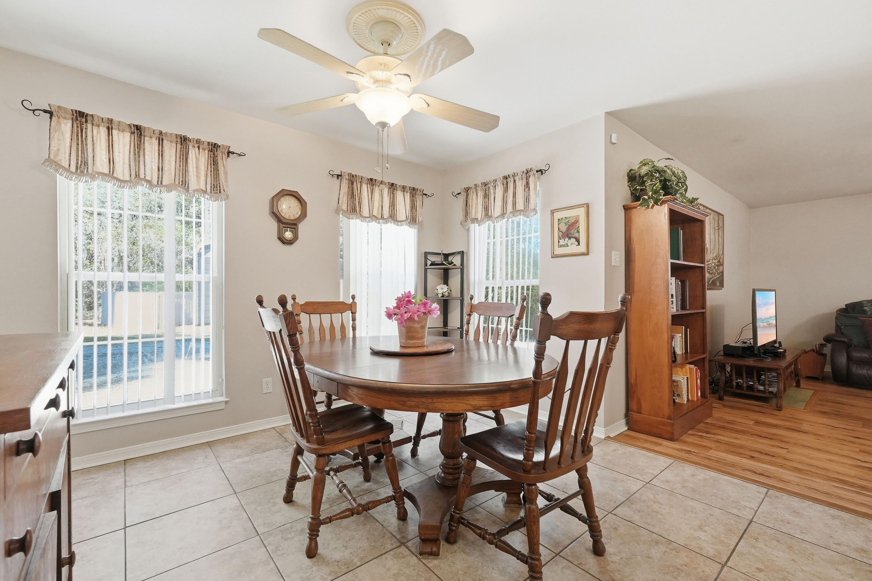 675 Spring Lake Road DeFuniak Springs, FL 32433 - Photo 24 of 91 a view of a dining room with furniture and a chandelier
