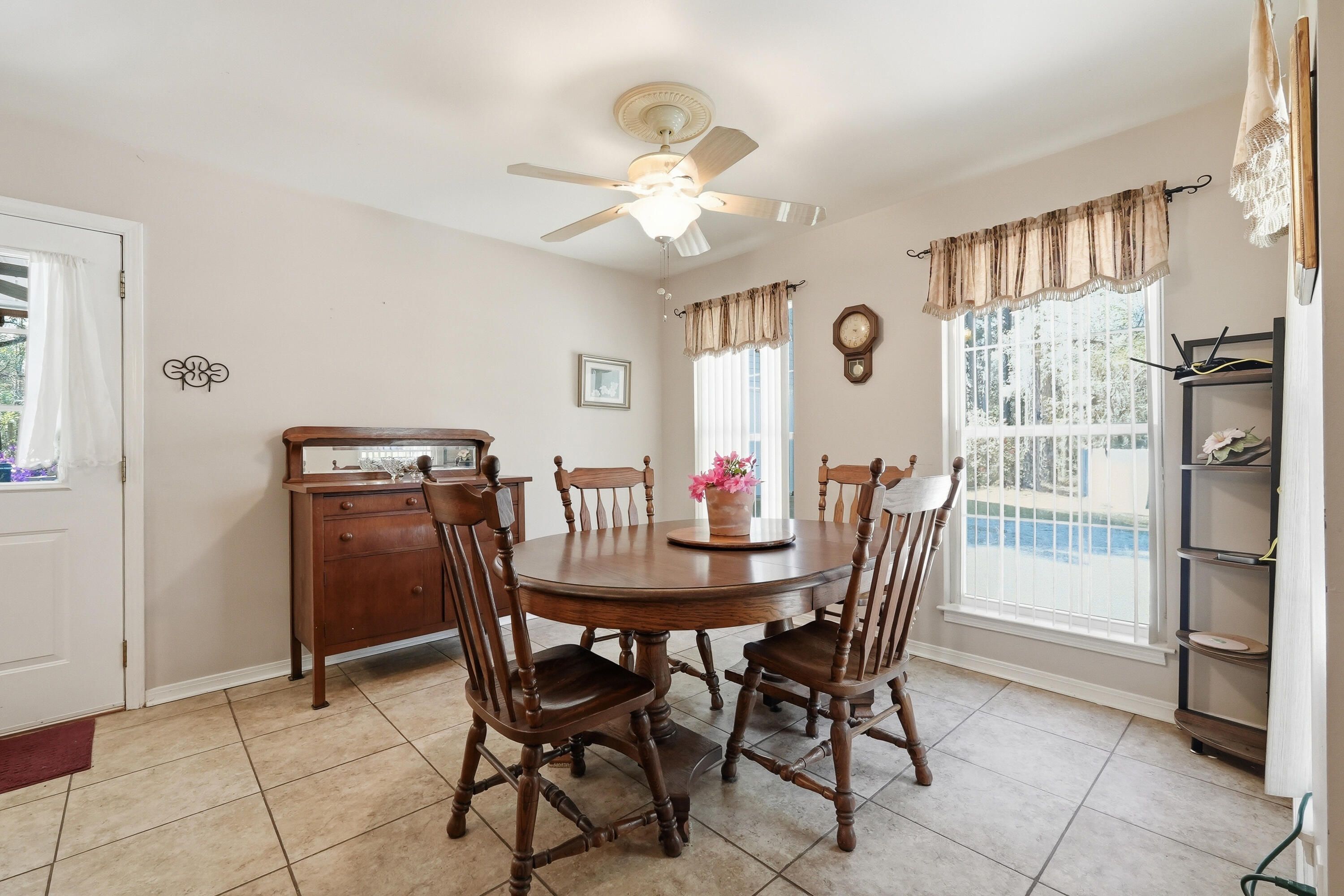 675 Spring Lake Road DeFuniak Springs, FL 32433 - Photo 25 of 91 a view of a dining room with furniture and a chandelier
