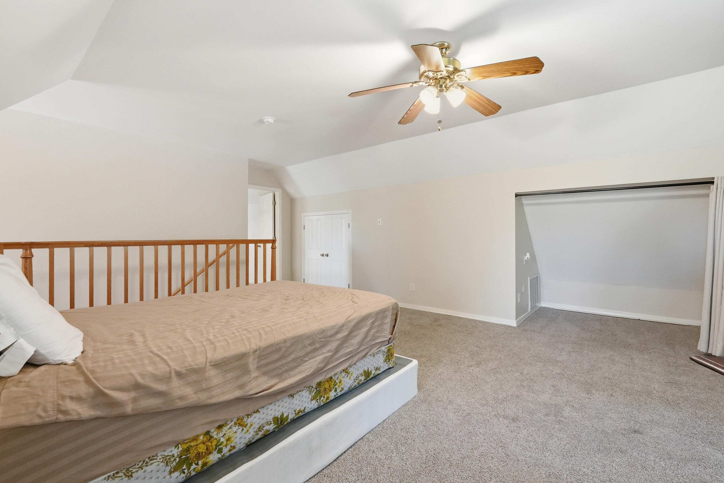 675 Spring Lake Road DeFuniak Springs, FL 32433 - Photo 45 of 91 a bedroom with a bed and a chandelier