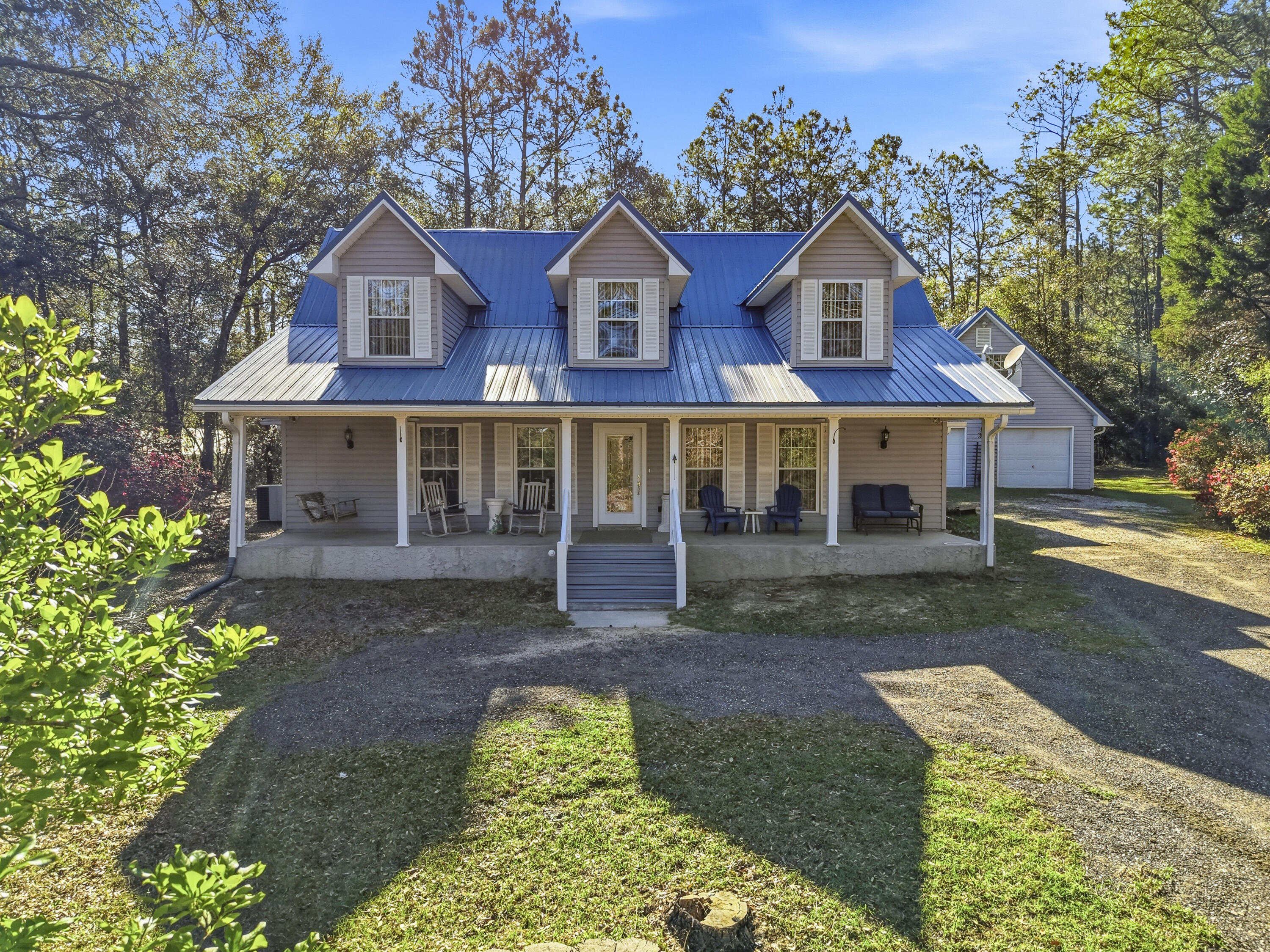 675 Spring Lake Road DeFuniak Springs, FL 32433 - Photo 5 of 91 a view of a yard in front of a house with large windows