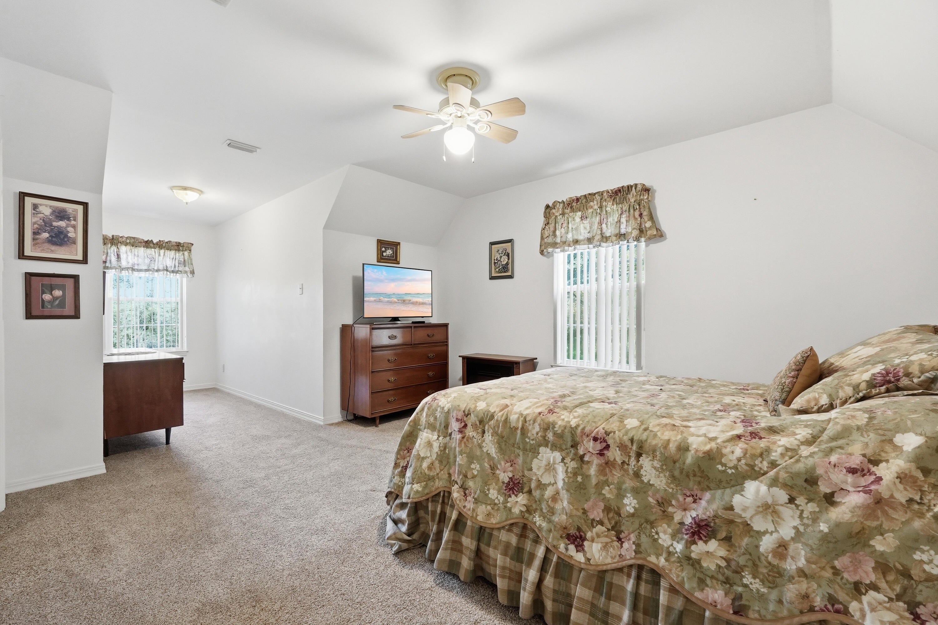 675 Spring Lake Road DeFuniak Springs, FL 32433 - Photo 51 of 91 a bedroom with a bed and a chandelier
