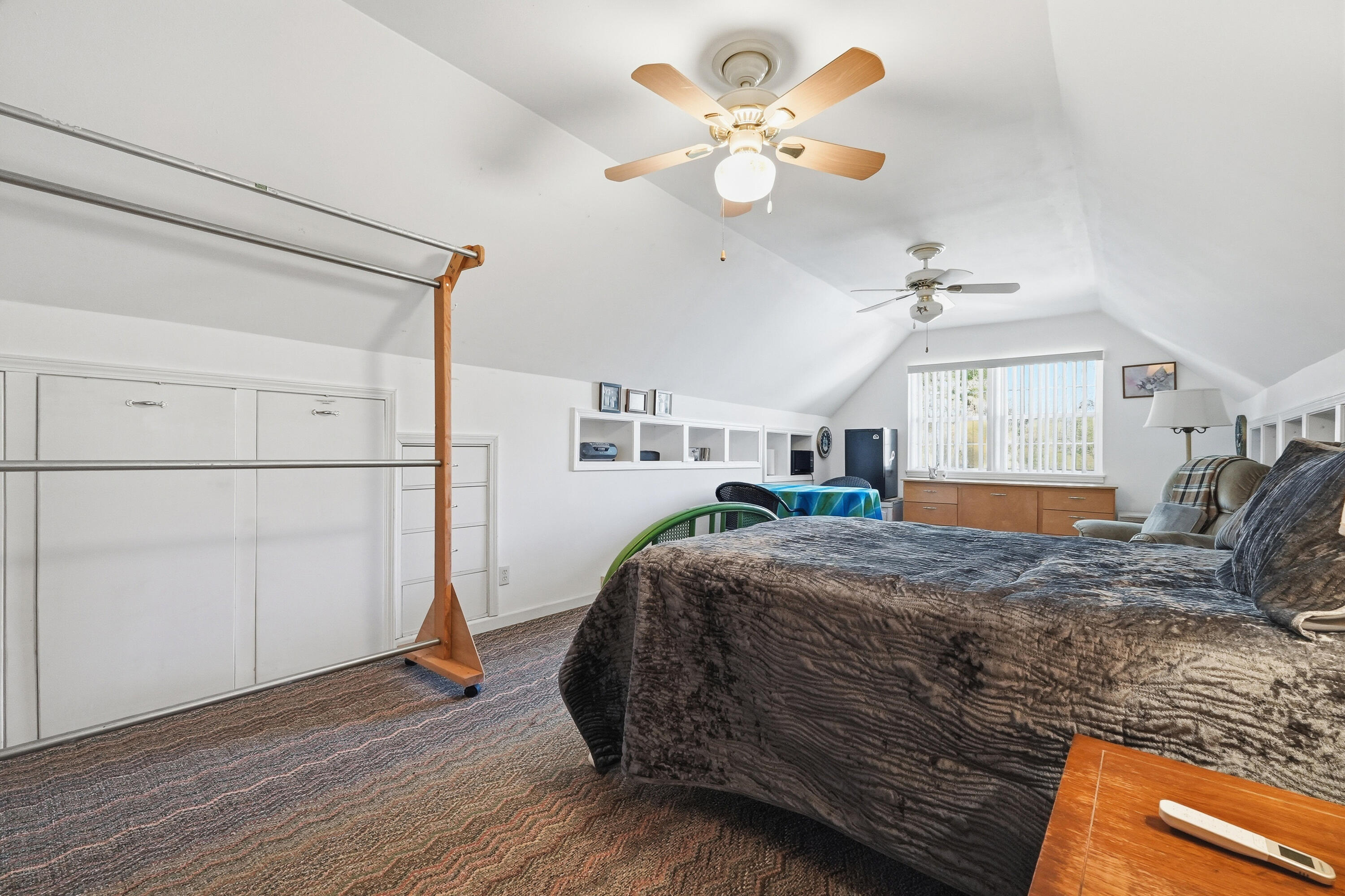 675 Spring Lake Road DeFuniak Springs, FL 32433 - Photo 56 of 91 a bedroom with a bed chandelier and a window