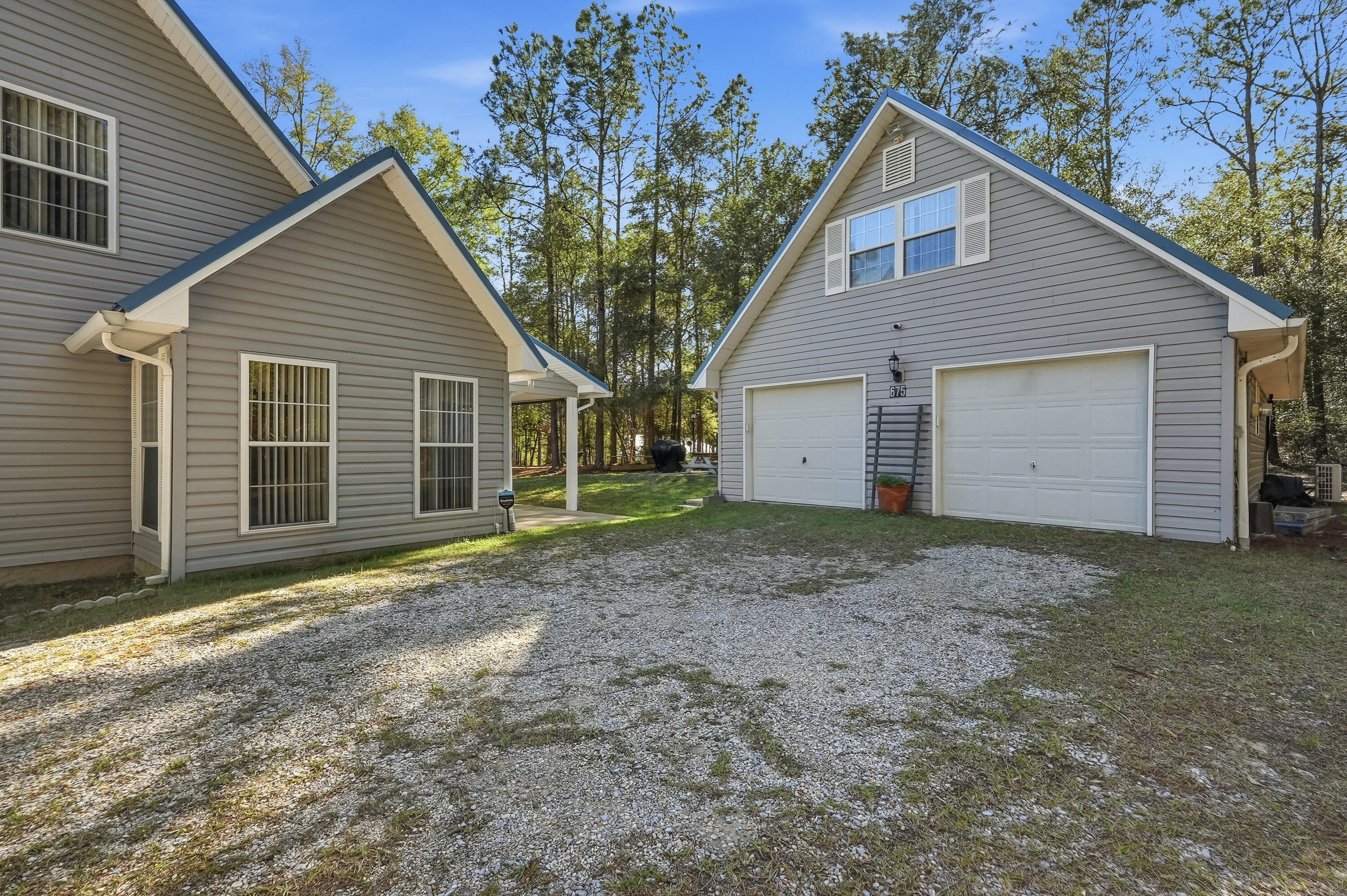 675 Spring Lake Road DeFuniak Springs, FL 32433 - Photo 75 of 91 a view of a house with a yard and garage