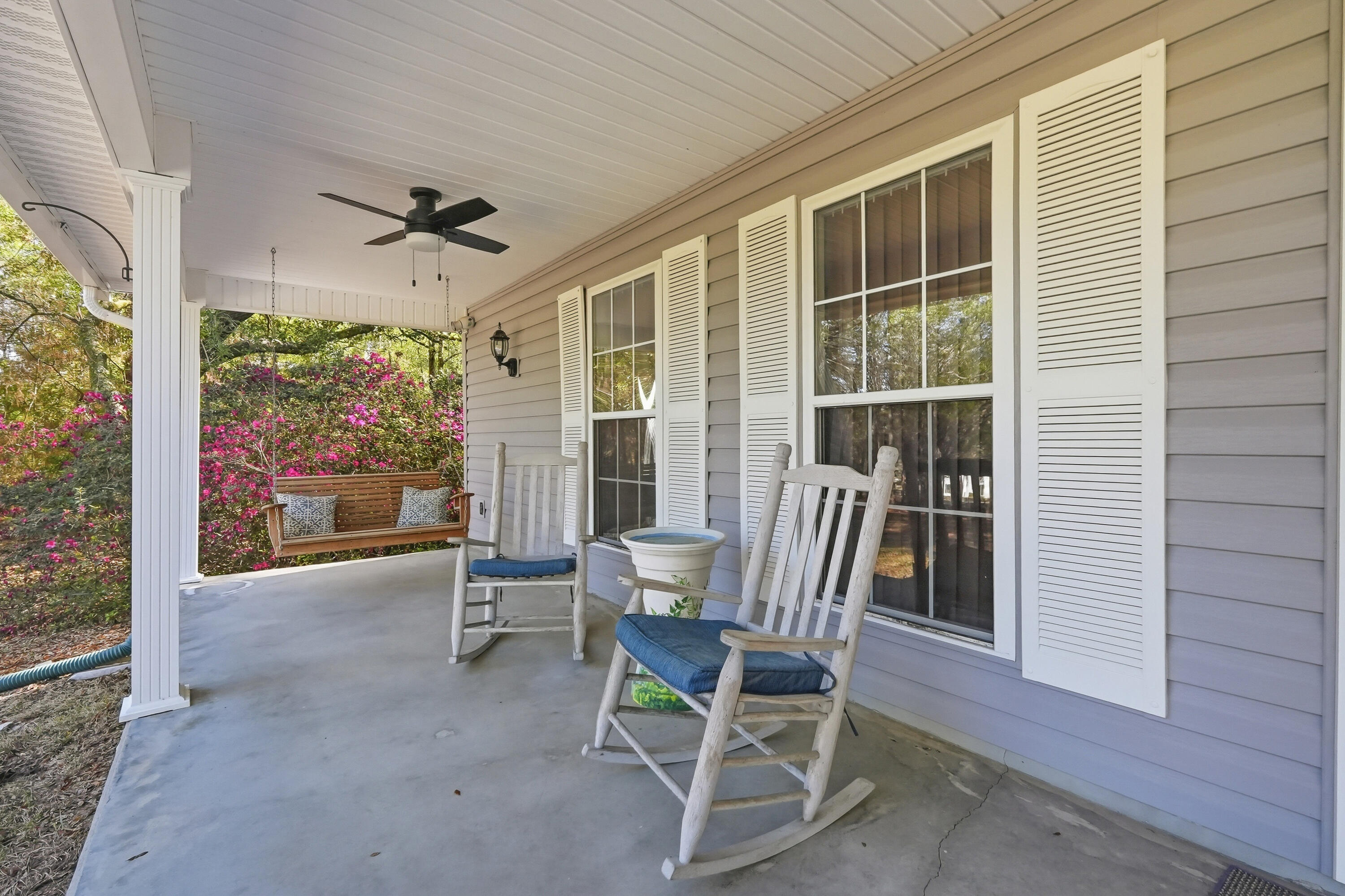 675 Spring Lake Road DeFuniak Springs, FL 32433 - Photo 8 of 91 a view of a porch with chairs and backyard