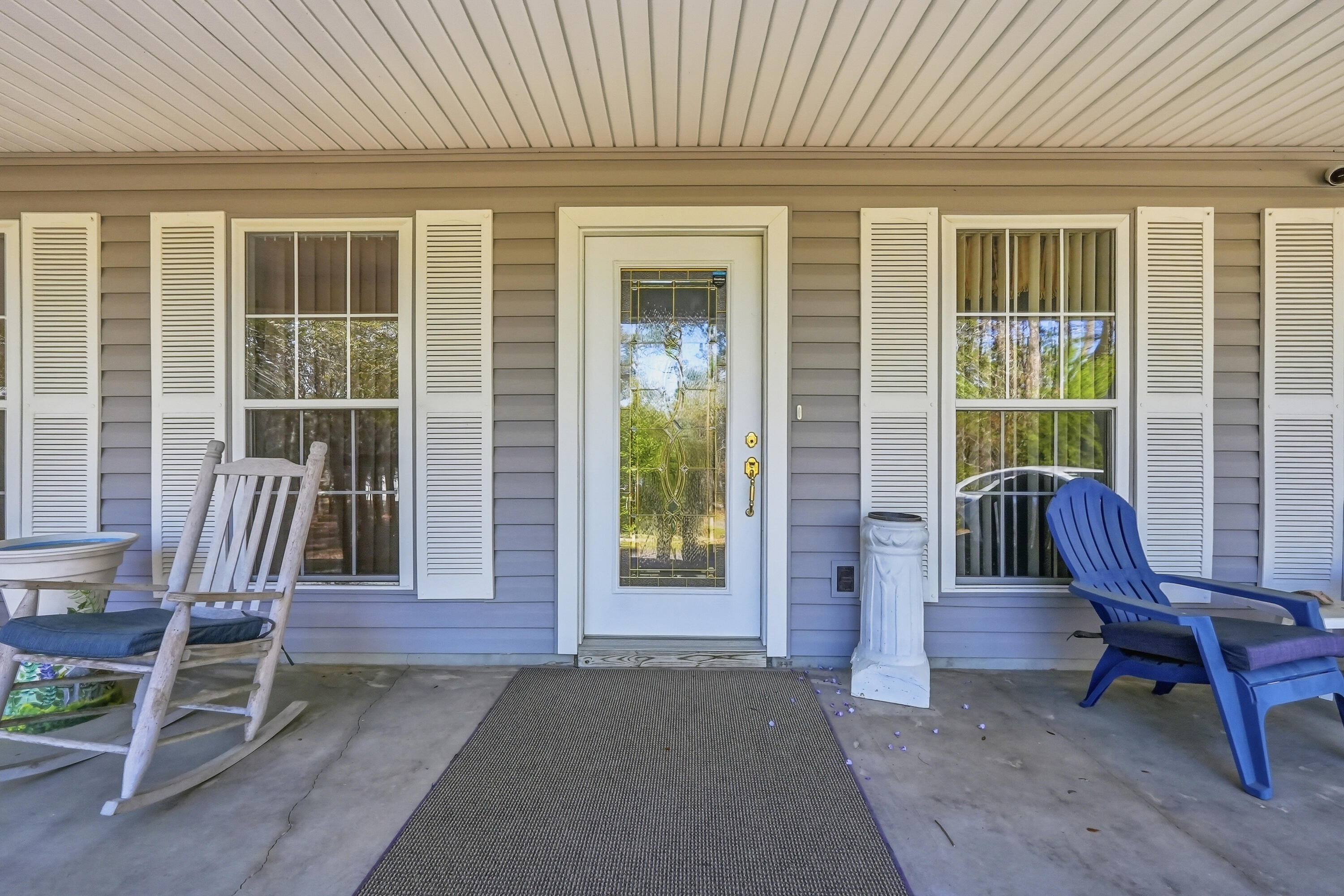 675 Spring Lake Road DeFuniak Springs, FL 32433 - Photo 10 of 91 a view of a deck with table and chairs and wooden floor