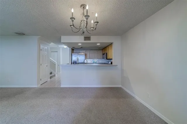 a white toilet sitting next to a white sink and vanity