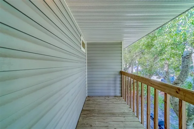 a view of an empty room with a chandelier fan