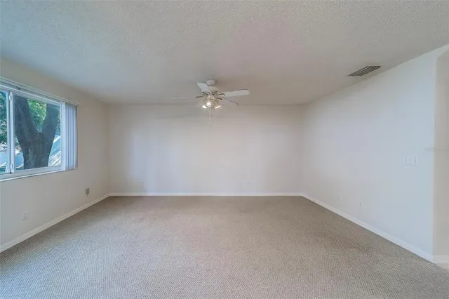 an aerial view of a house with a garden and lake view