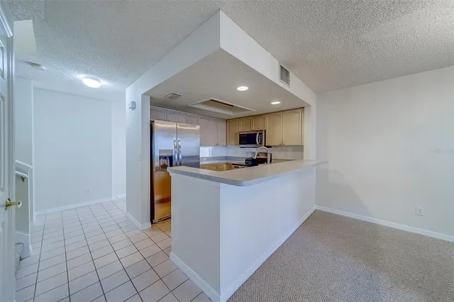 a kitchen with a refrigerator and cabinets
