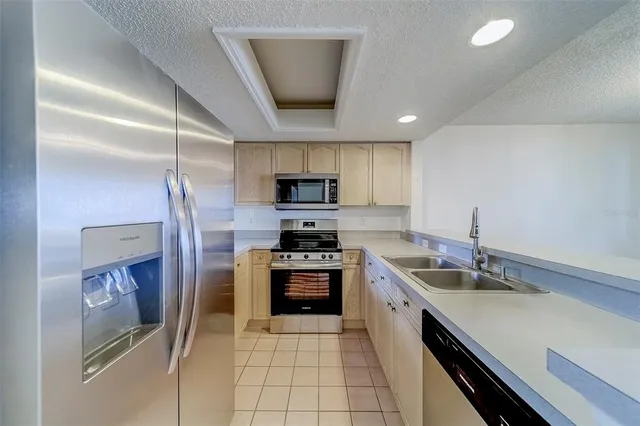 a kitchen with granite countertop a stove sink and cabinets