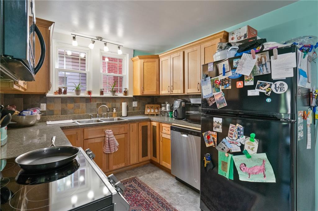 229 Dewey Street Pittsburgh, PA 15218 - Photo 11 of 33 a kitchen with lots of counter top space and furniture