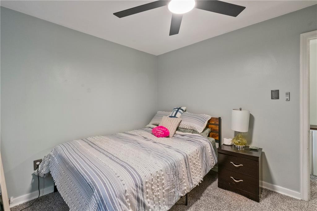 229 Dewey Street Pittsburgh, PA 15218 - Photo 21 of 33 a bedroom with a bed and a ceiling fan