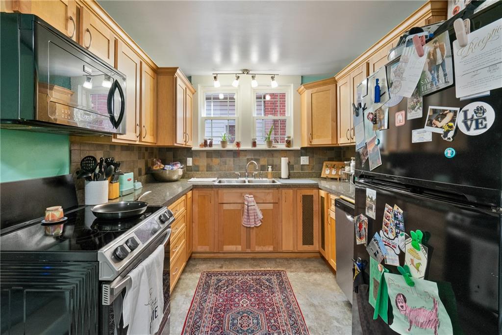 229 Dewey Street Pittsburgh, PA 15218 - Photo 10 of 33 a kitchen with stainless steel appliances granite countertop a stove a sink and a microwave