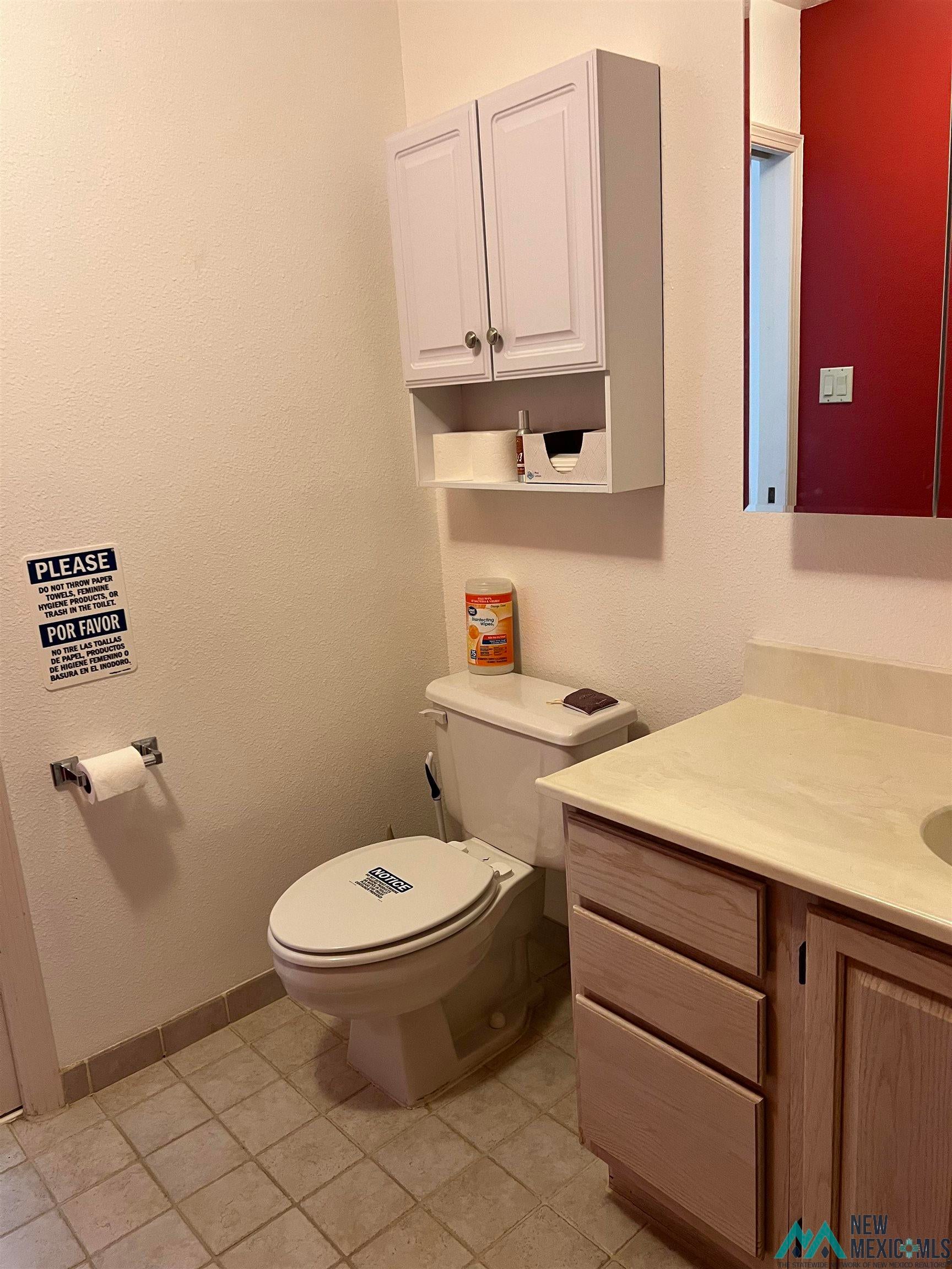 109 Mimbres Road Elephant Butte, NM 87935 - Photo 21 of 27 Half bath featuring a textured wall, vanity, and light tile patterned floors