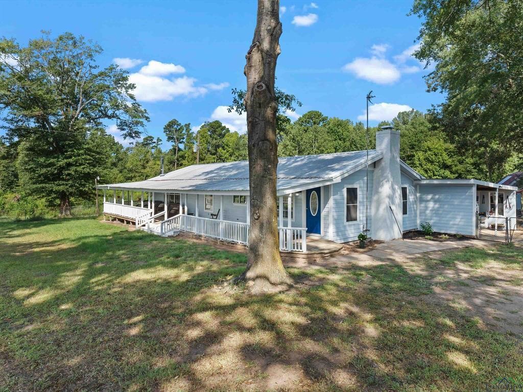6006 Highway 315 Carthage, TX 75633 - Photo 13 of 35 a front view of a house with garden