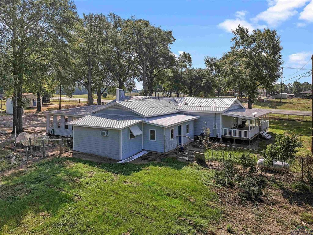 6006 Highway 315 Carthage, TX 75633 - Photo 28 of 35 an aerial view of a house with a garden and trees